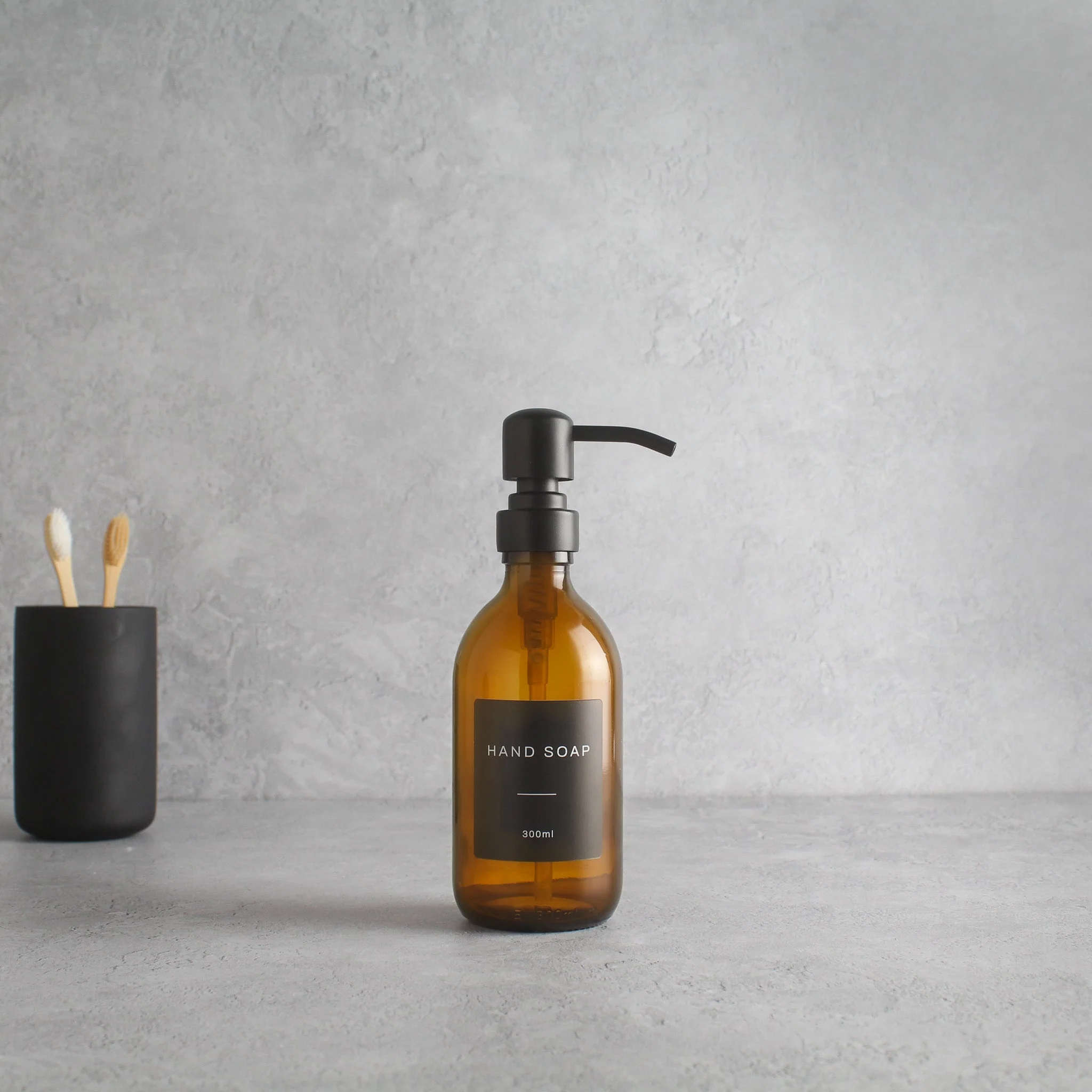 Labelled Amber Glass Dispenser Bottle With Matte Black Pump - Image 5