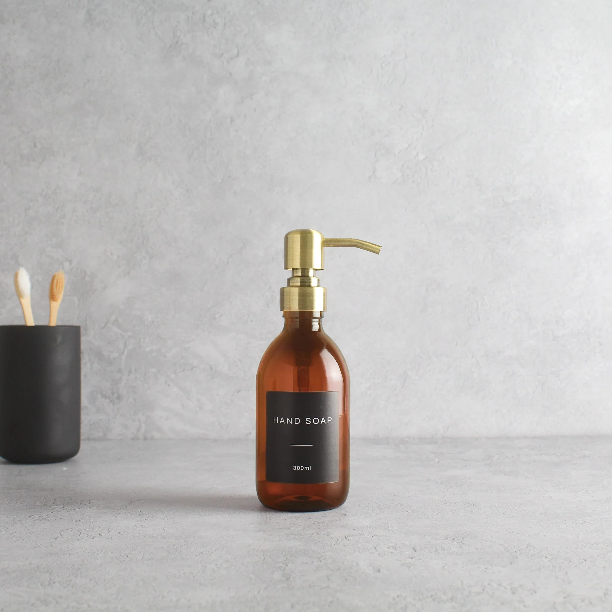 Labelled Amber Plastic Dispenser Bottle With Gold Pump - Image 5