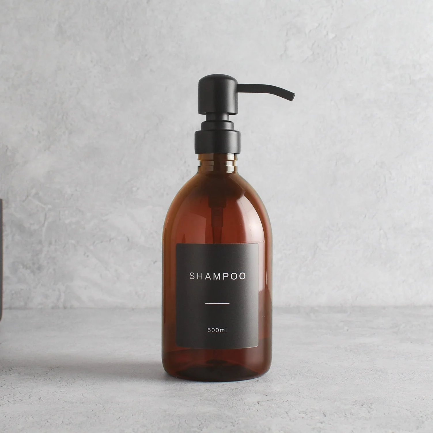 Labelled Amber Plastic Dispenser Bottle With Matte Black Pump - Image 4