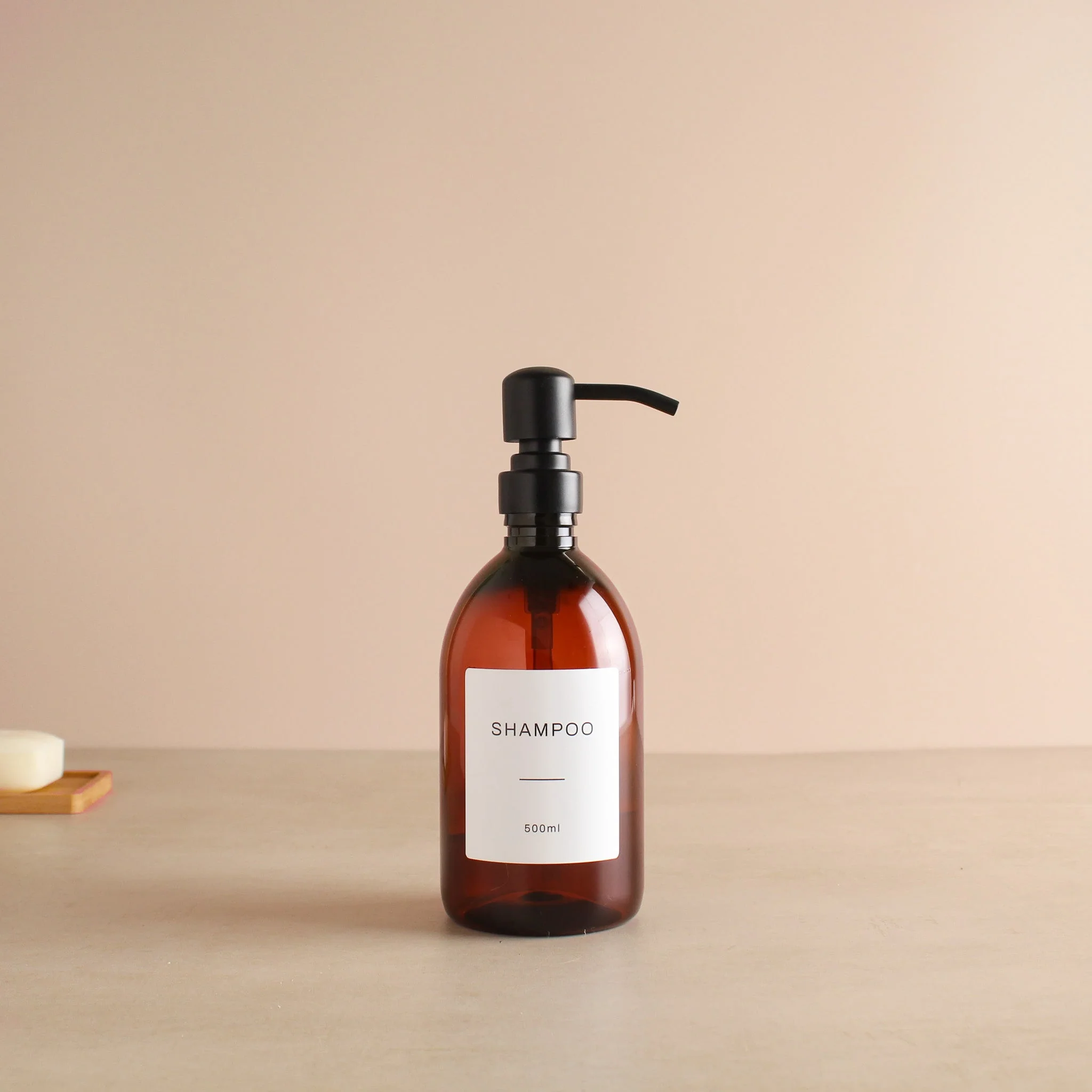 Labelled Amber Plastic Dispenser Bottle With Matte Black Pump - Image 4