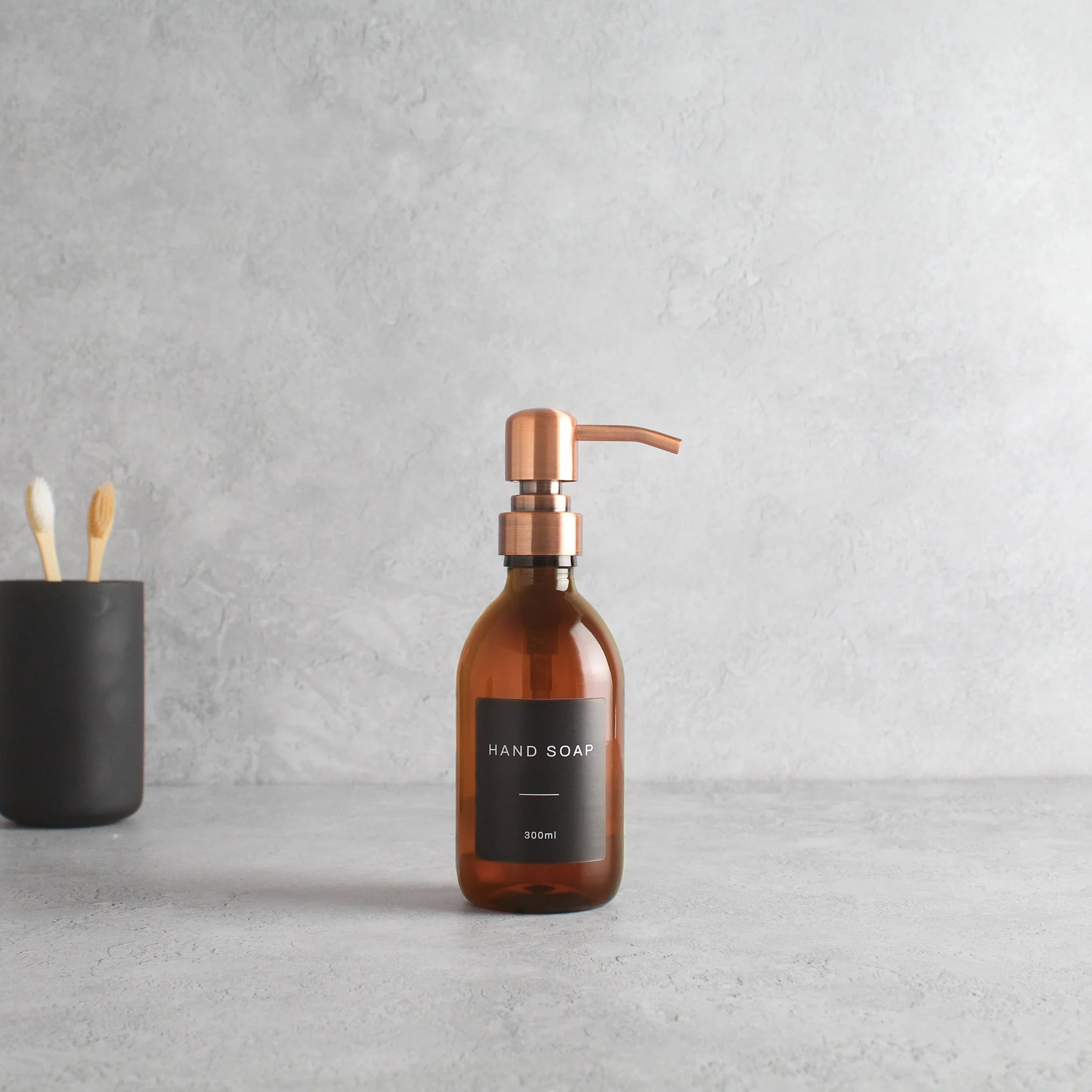 Labelled Amber Plastic Dispenser Bottle With Rose Gold Pump - Image 5