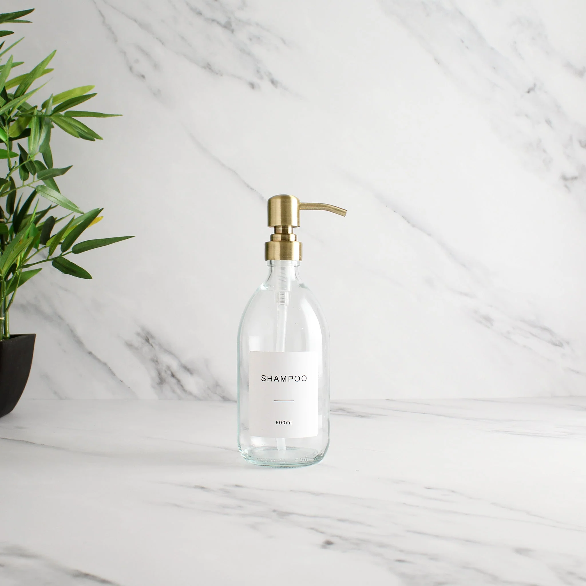 Labelled Clear Glass Dispenser Bottle With Gold Pump - Image 4