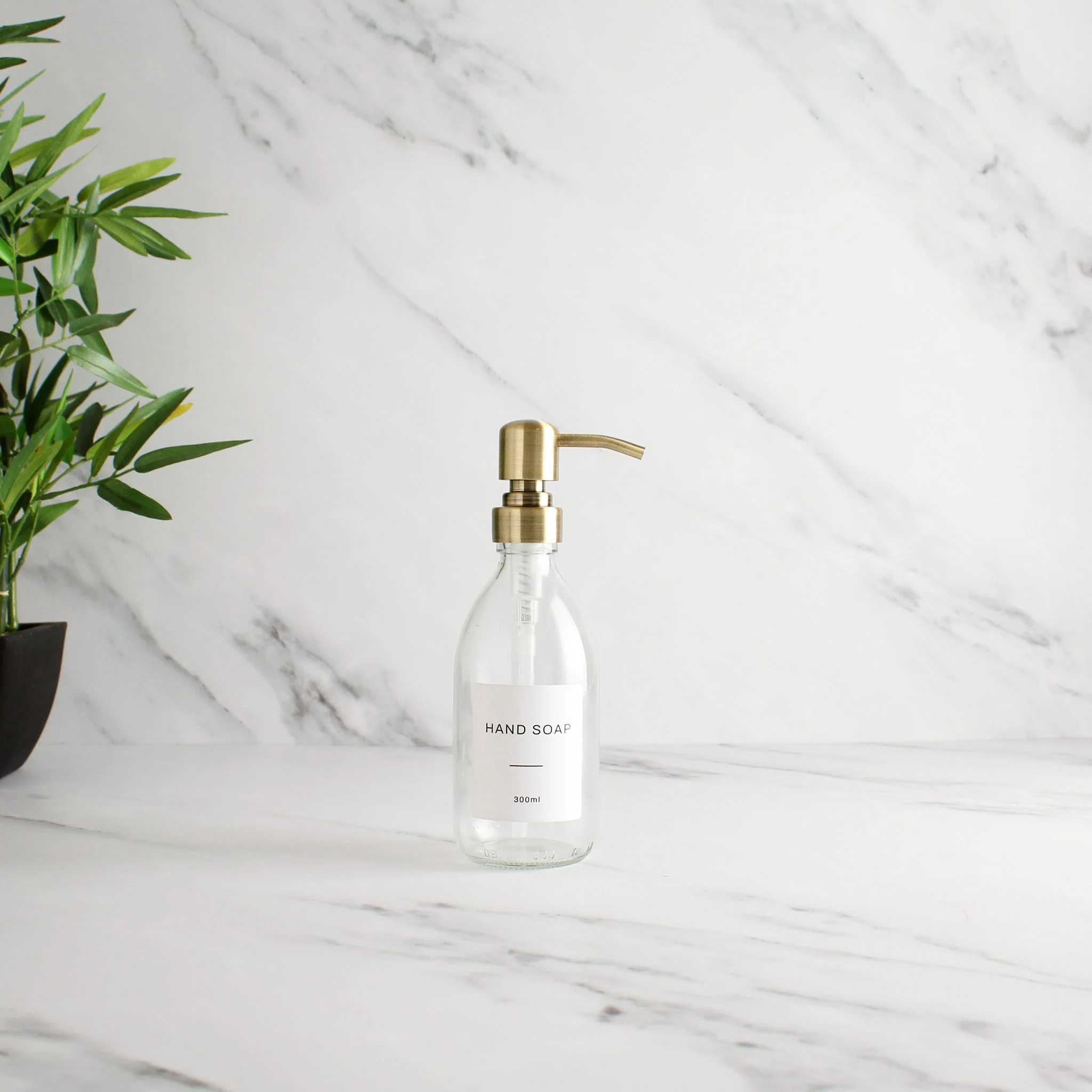 Labelled Clear Glass Dispenser Bottle With Gold Pump - Image 5