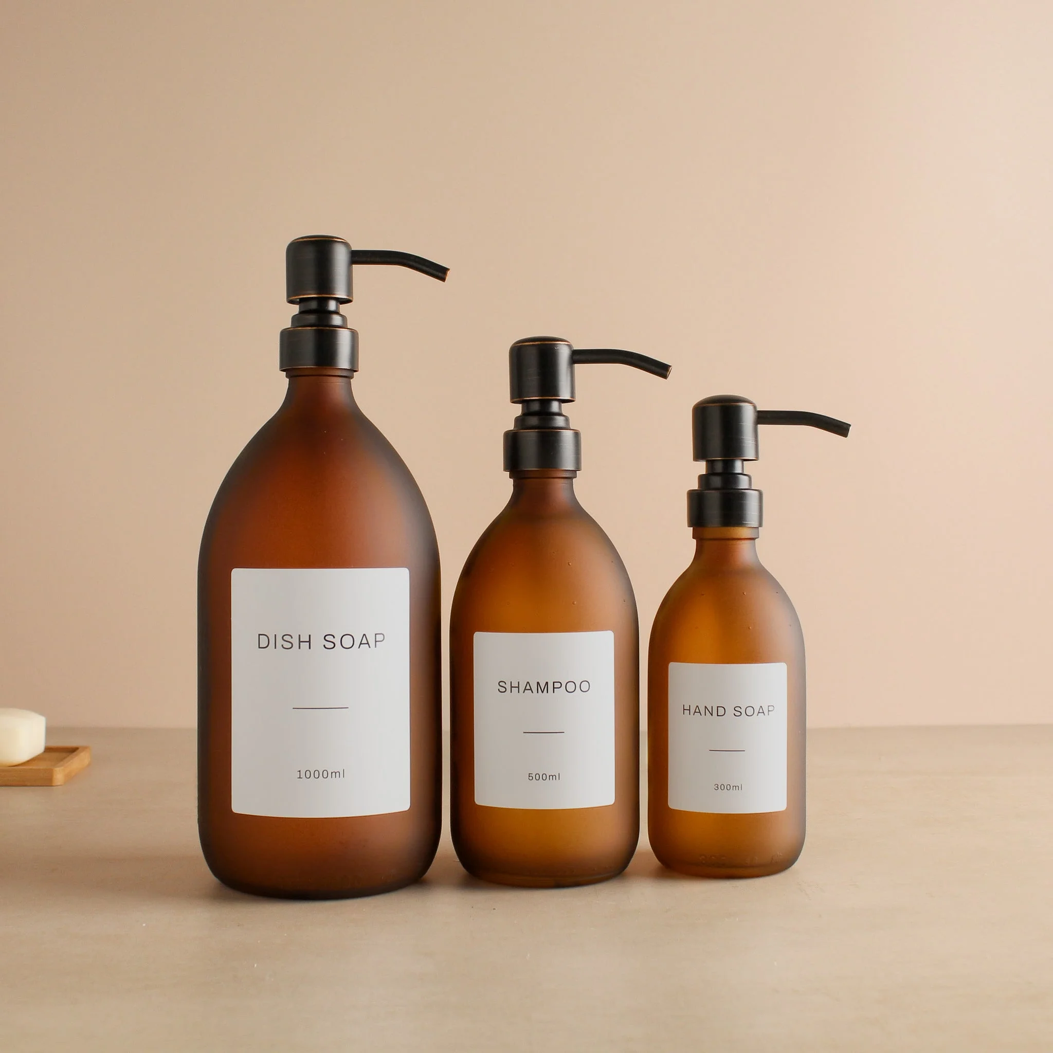 Labelled Frosted Amber Glass Dispenser Bottle With Black/Copper Pump - Image 2