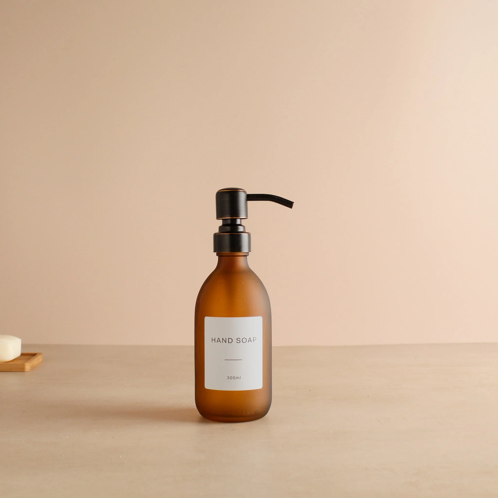 Labelled Frosted Amber Glass Dispenser Bottle With Black/Copper Pump - Image 5