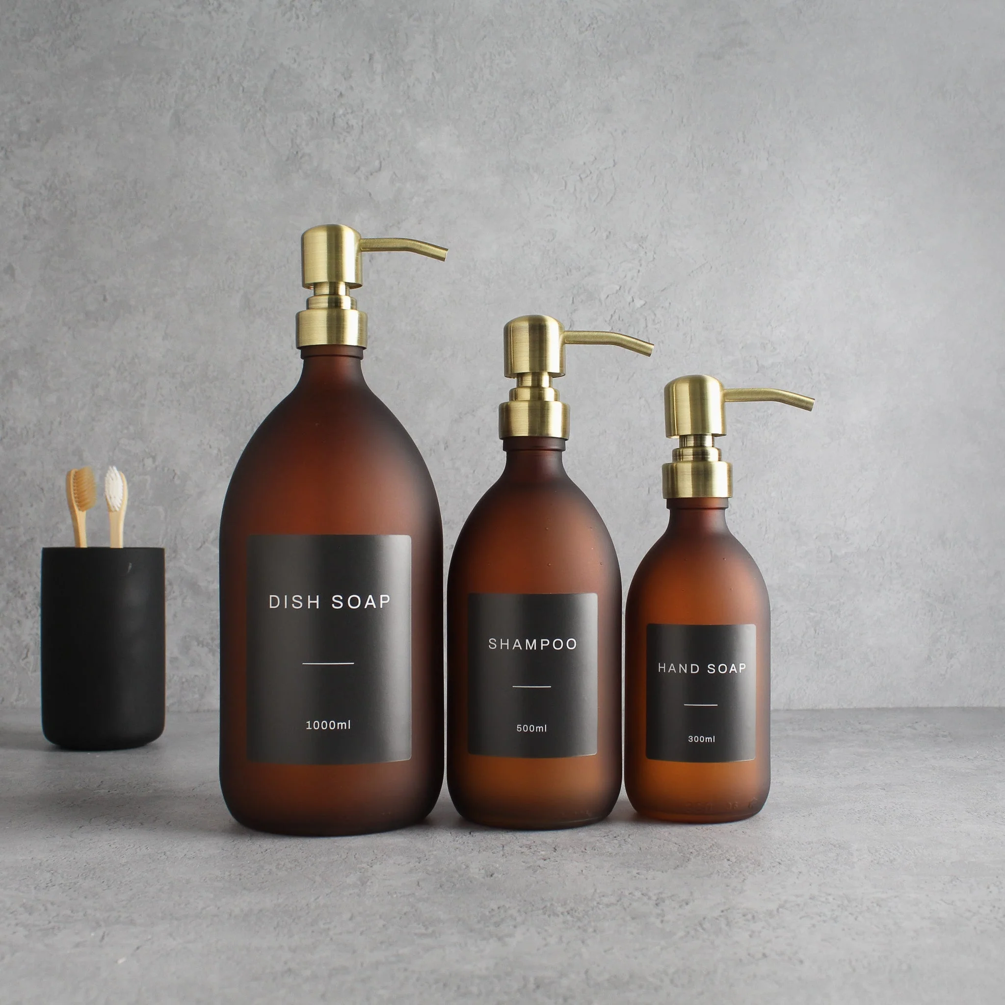 Labelled Frosted Amber Glass Dispenser Bottle With Gold Pump - Image 2
