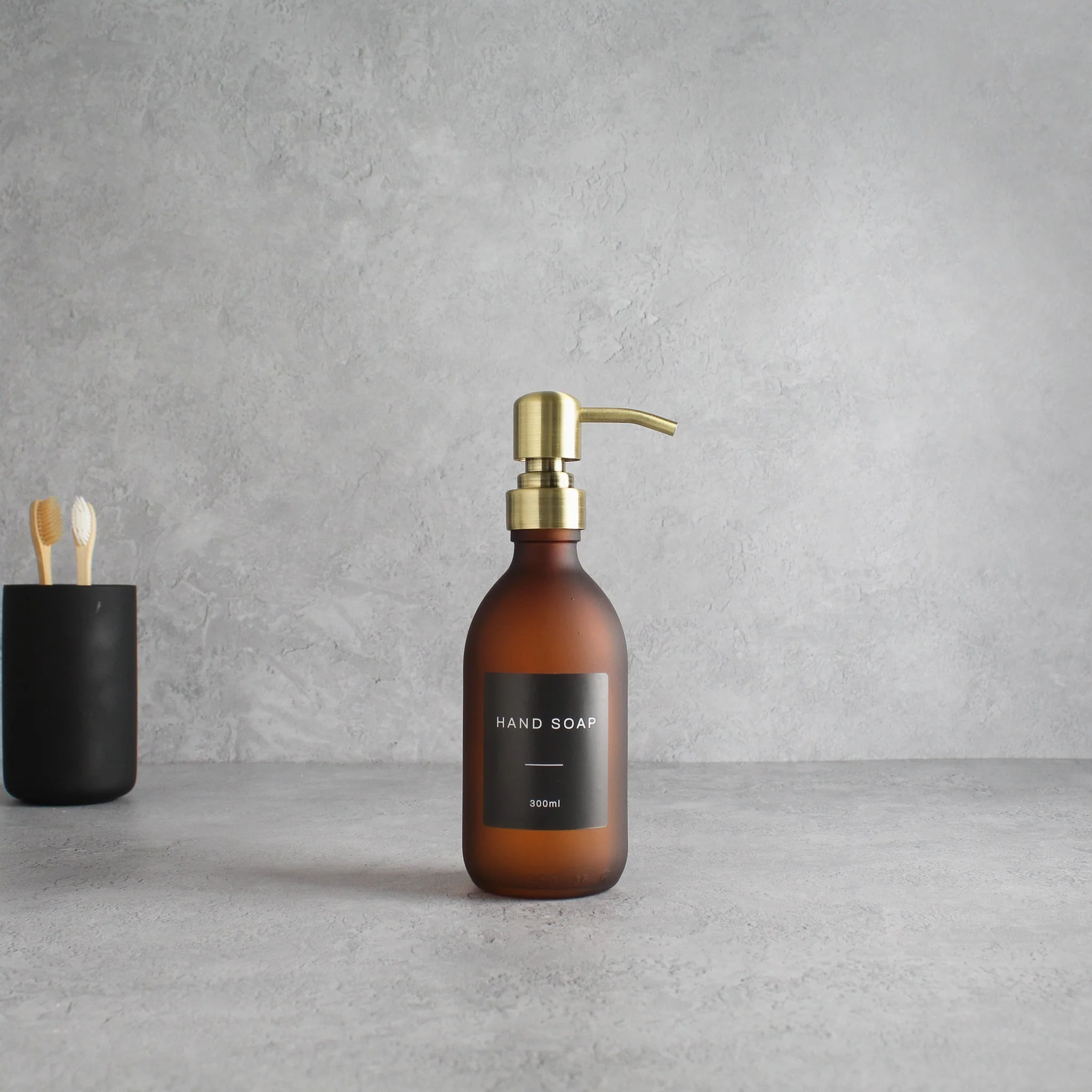 Labelled Frosted Amber Glass Dispenser Bottle With Gold Pump - Image 5