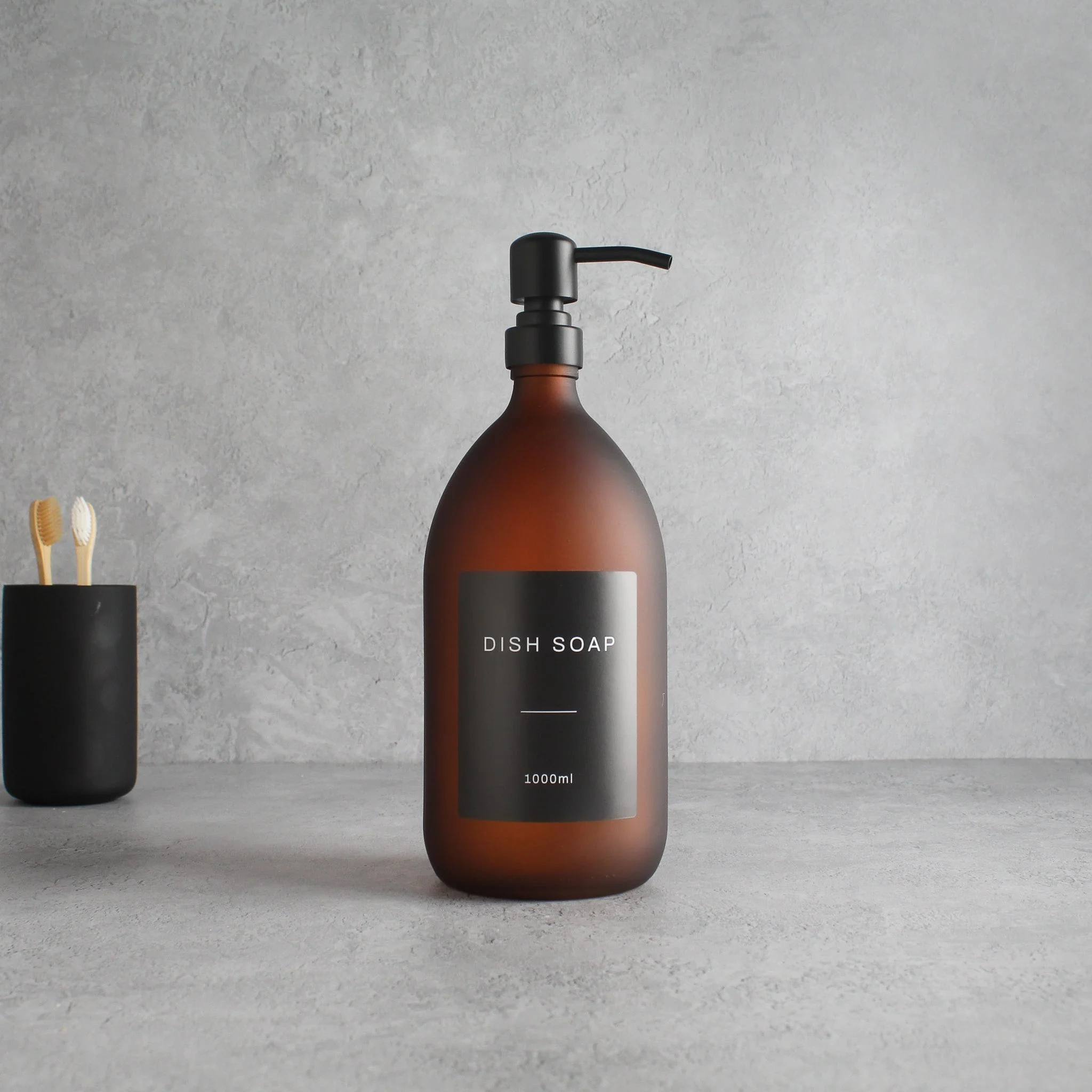 Labelled Frosted Amber Glass Dispenser Bottle With Matte Black Pump - Image 3
