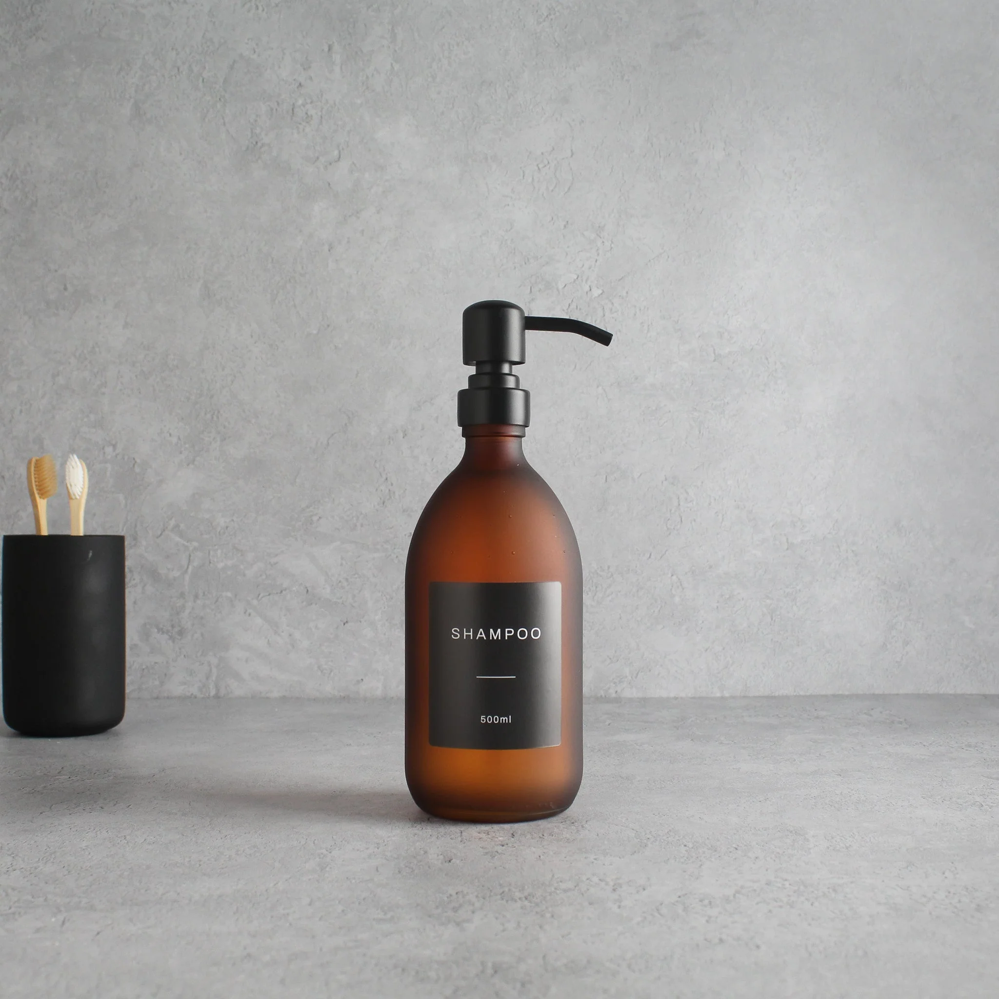 Labelled Frosted Amber Glass Dispenser Bottle With Matte Black Pump - Image 4