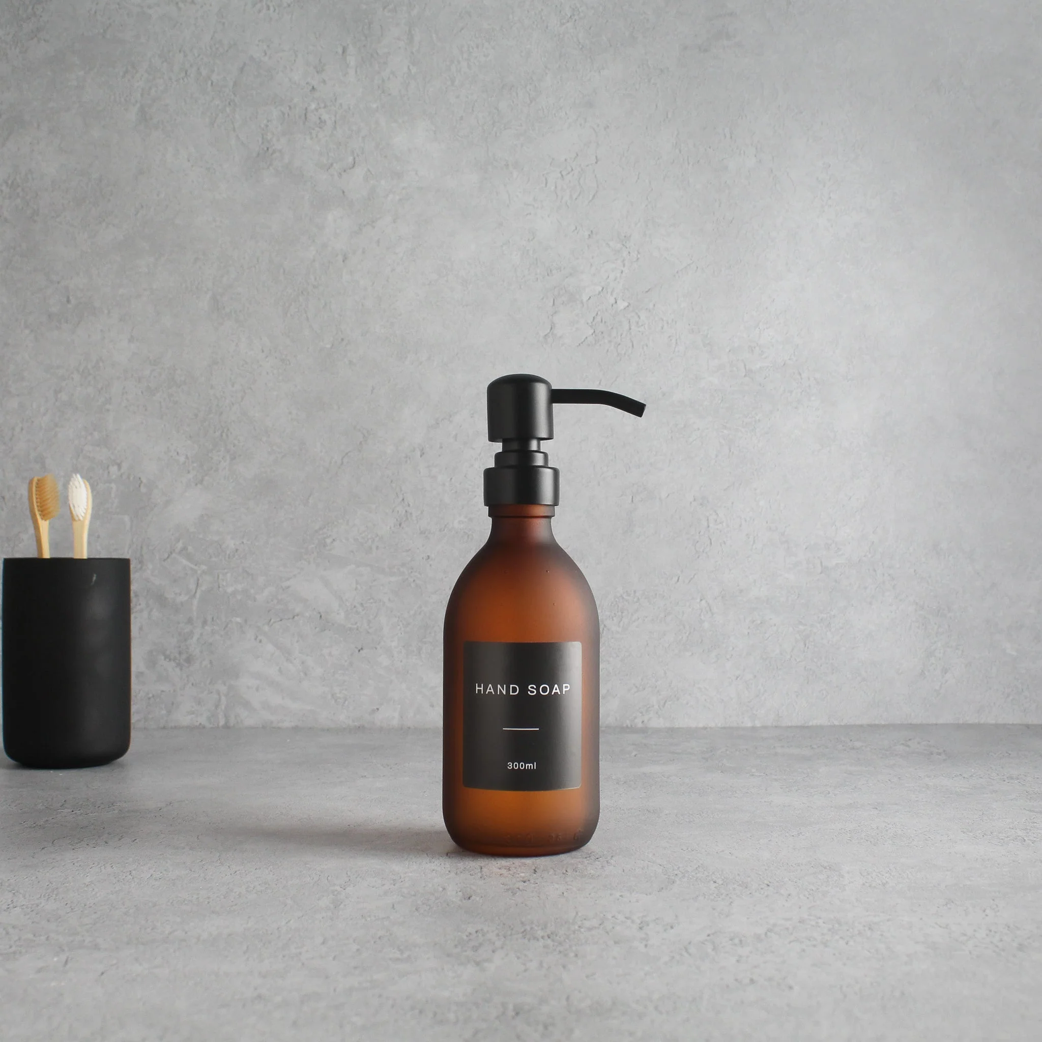 Labelled Frosted Amber Glass Dispenser Bottle With Matte Black Pump - Image 5