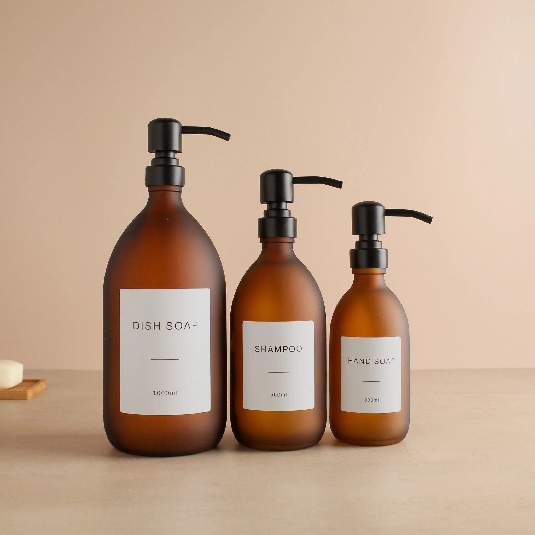 Labelled Frosted Amber Glass Dispenser Bottle With Matte Black Pump - Image 2