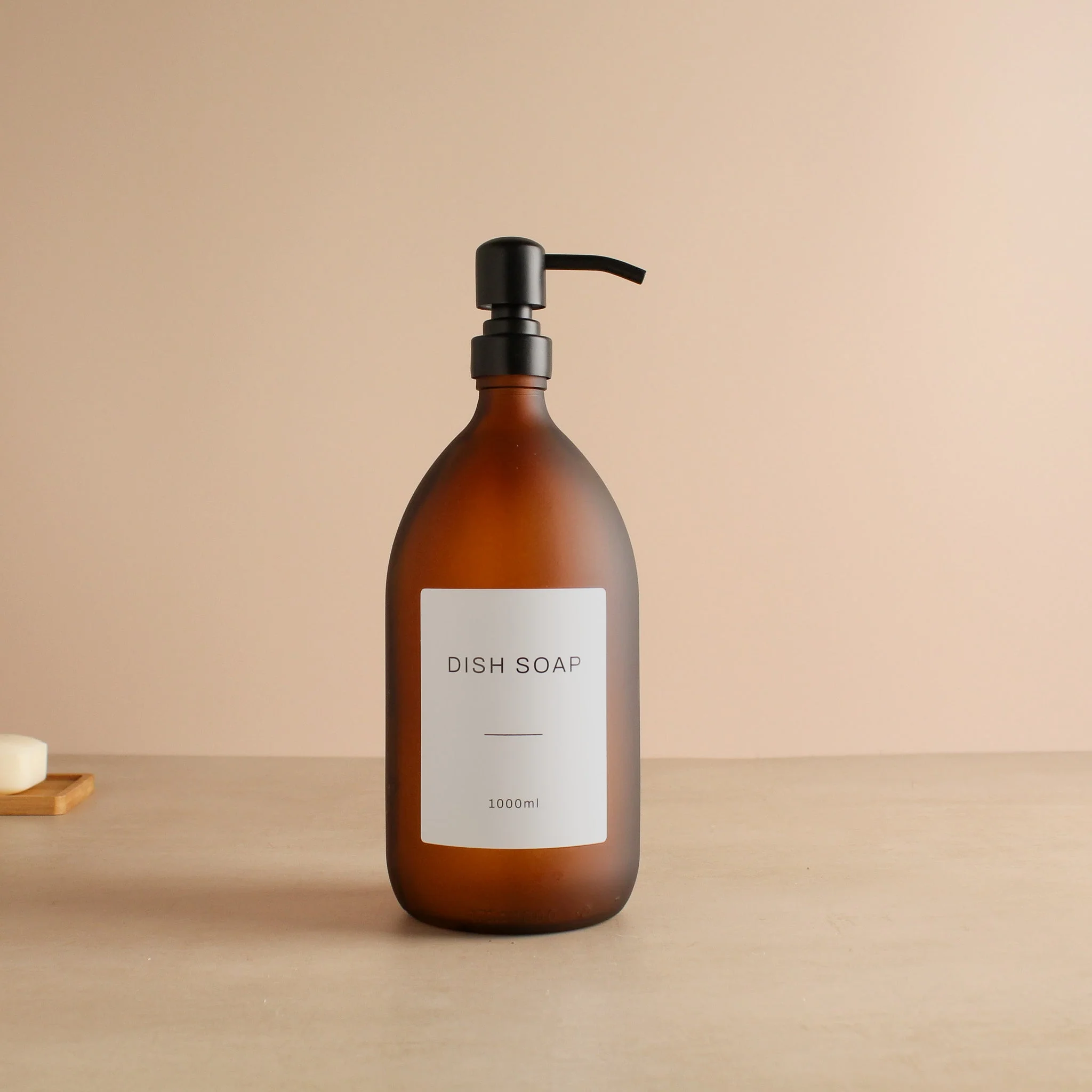 Labelled Frosted Amber Glass Dispenser Bottle With Matte Black Pump - Image 3