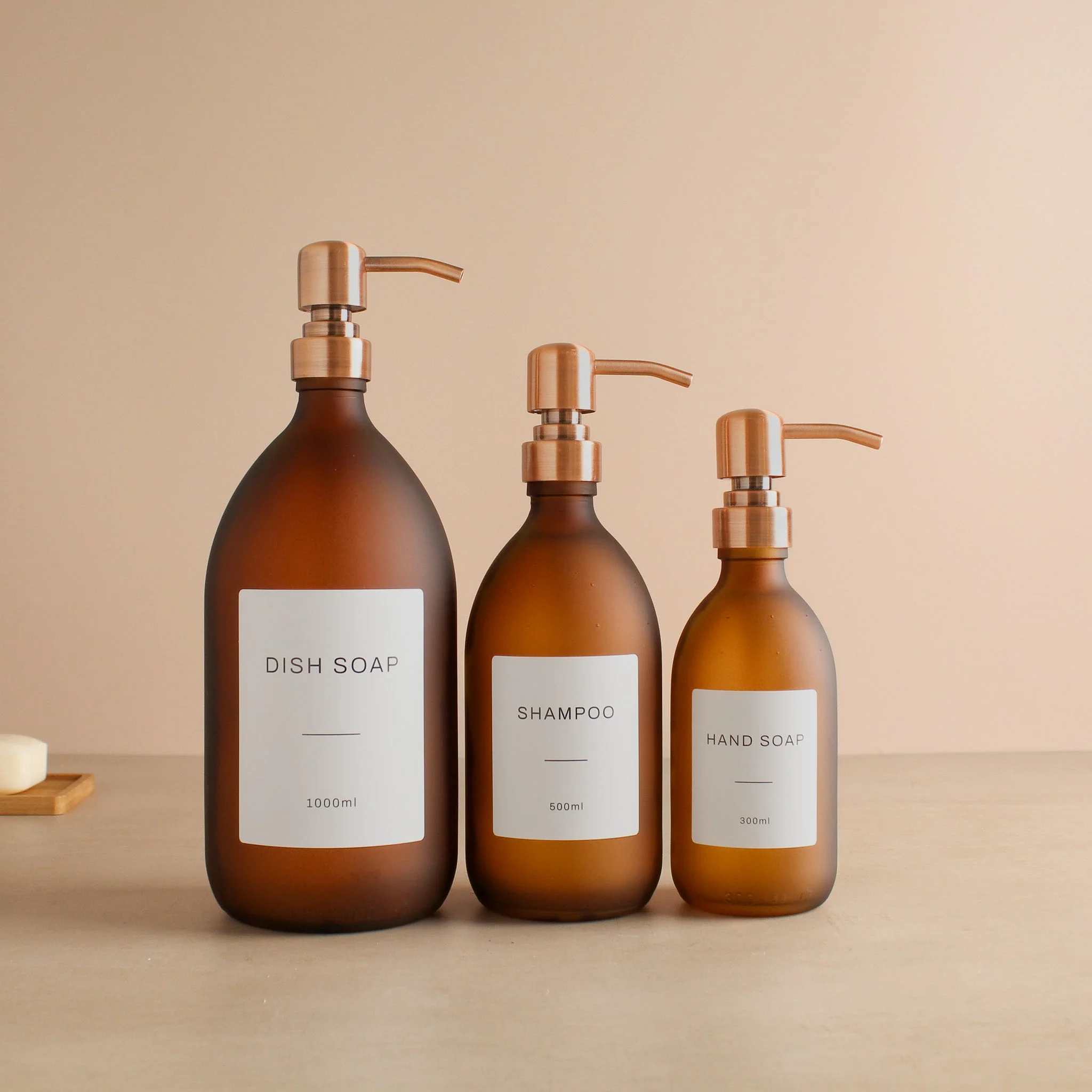 Labelled Frosted Amber Glass Dispenser Bottle With Rose Gold Pump - Image 2