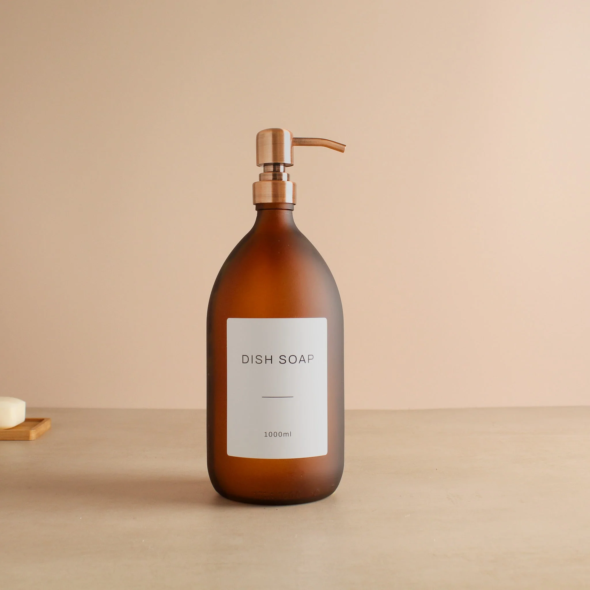Labelled Frosted Amber Glass Dispenser Bottle With Rose Gold Pump - Image 3