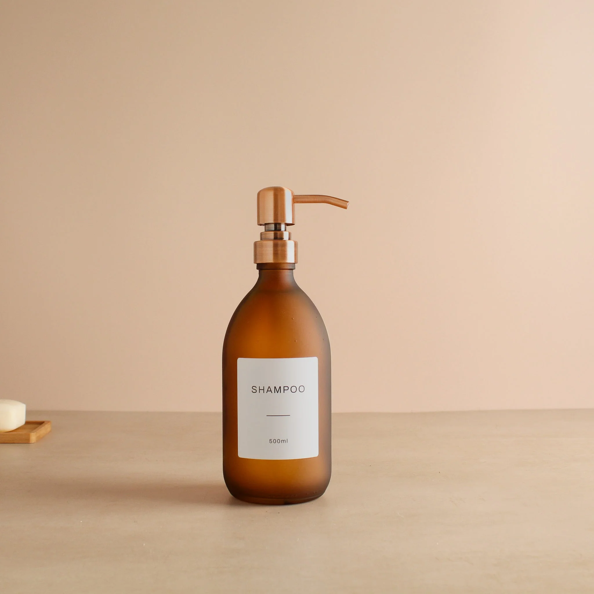 Labelled Frosted Amber Glass Dispenser Bottle With Rose Gold Pump - Image 4