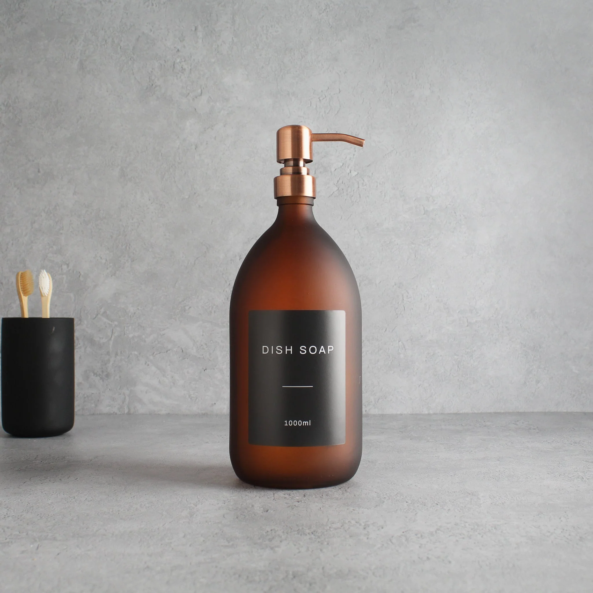 Labelled Frosted Amber Glass Dispenser Bottle With Rose Gold Pump - Image 3