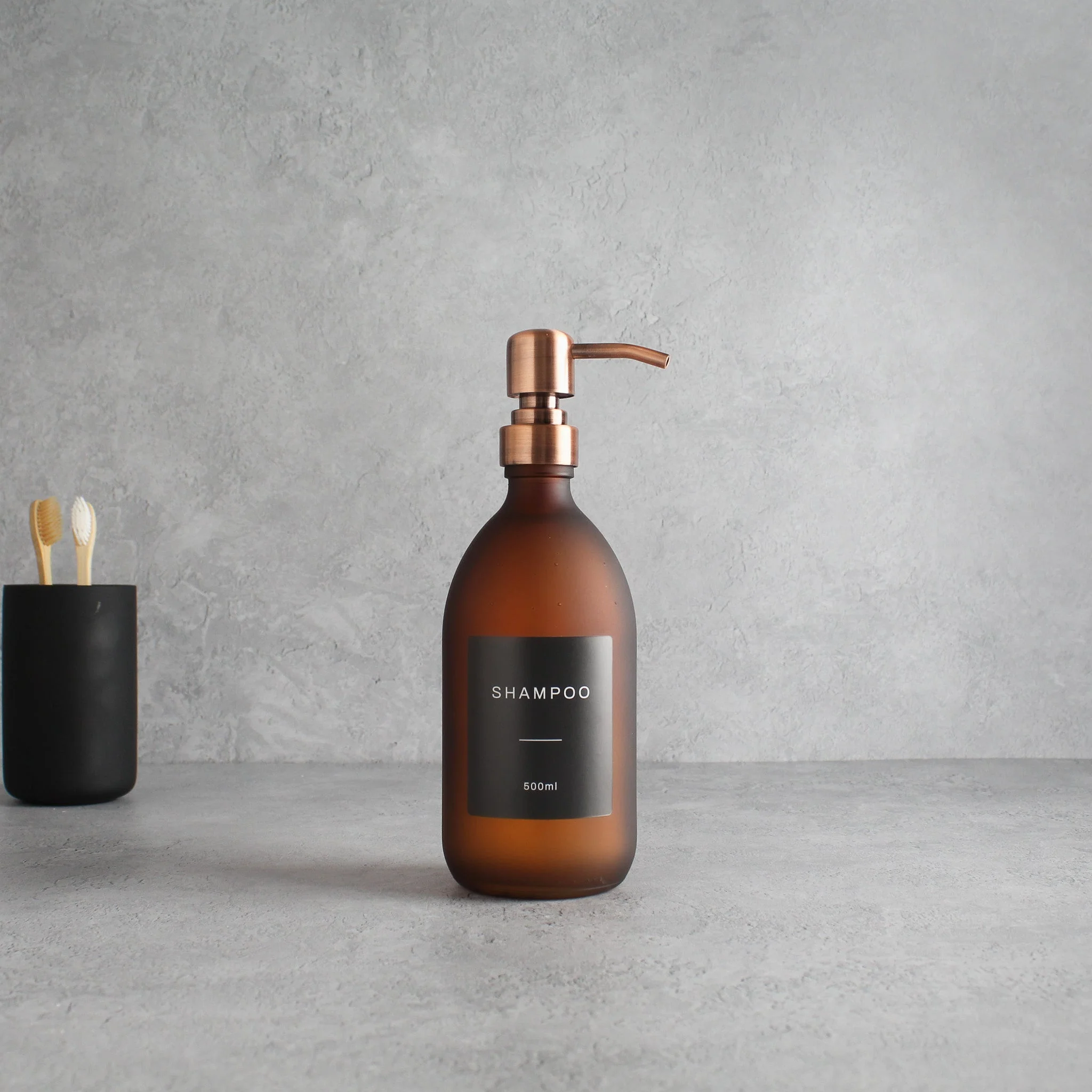 Labelled Frosted Amber Glass Dispenser Bottle With Rose Gold Pump - Image 4