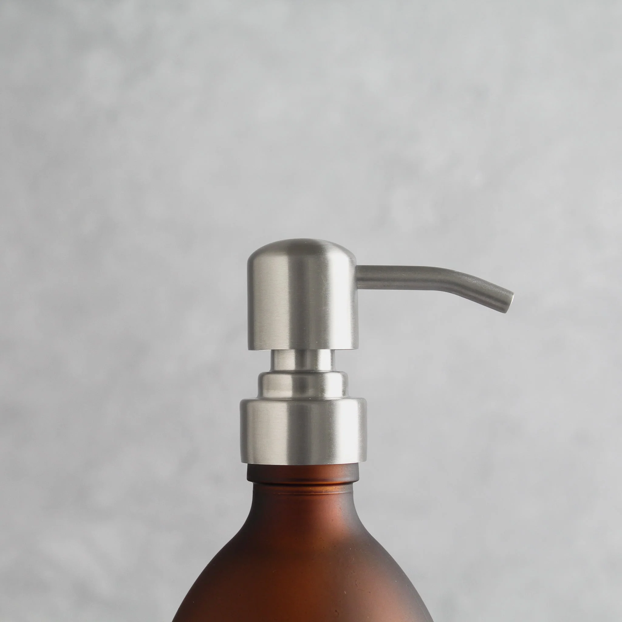Labelled Frosted Amber Glass Dispenser Bottle With Silver Pump - Image 6