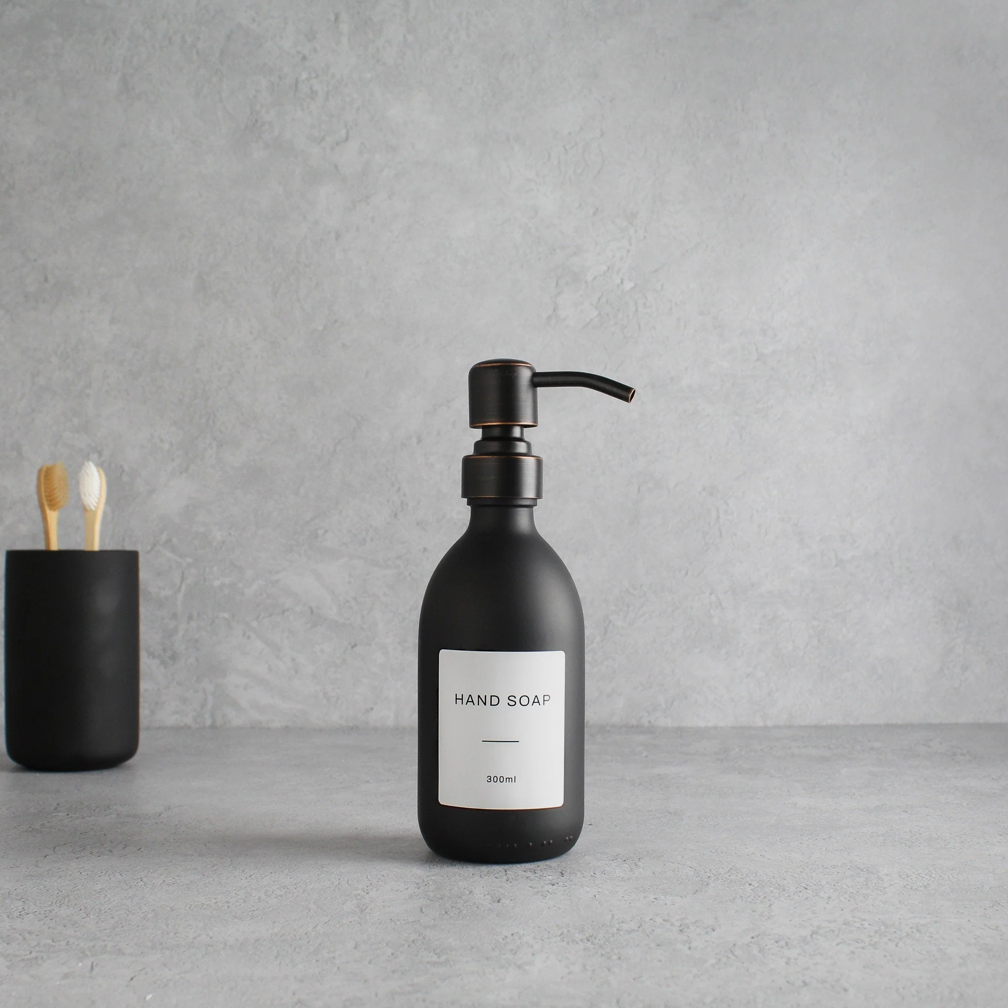 Labelled Matte Black Glass Dispenser Bottle With Black/Copper Pump - Image 5