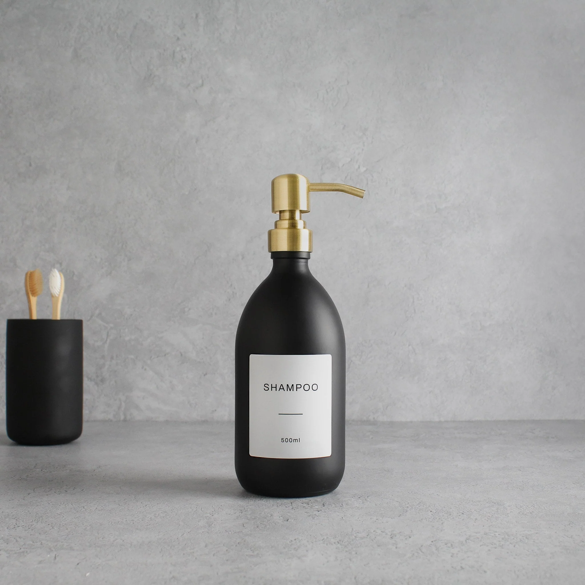 Labelled Matte Black Glass Dispenser Bottle With Gold Pump - Image 4