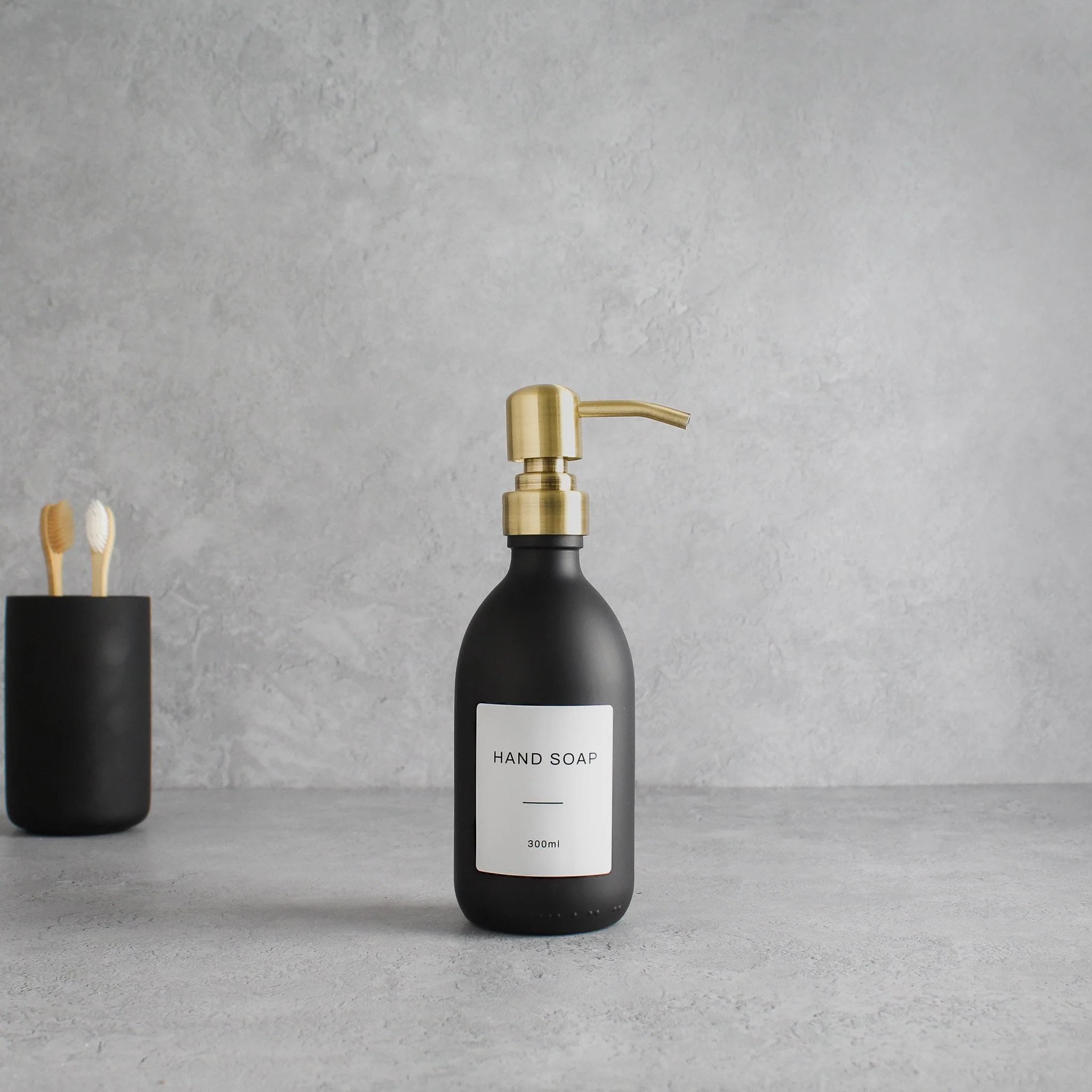 Labelled Matte Black Glass Dispenser Bottle With Gold Pump - Image 5
