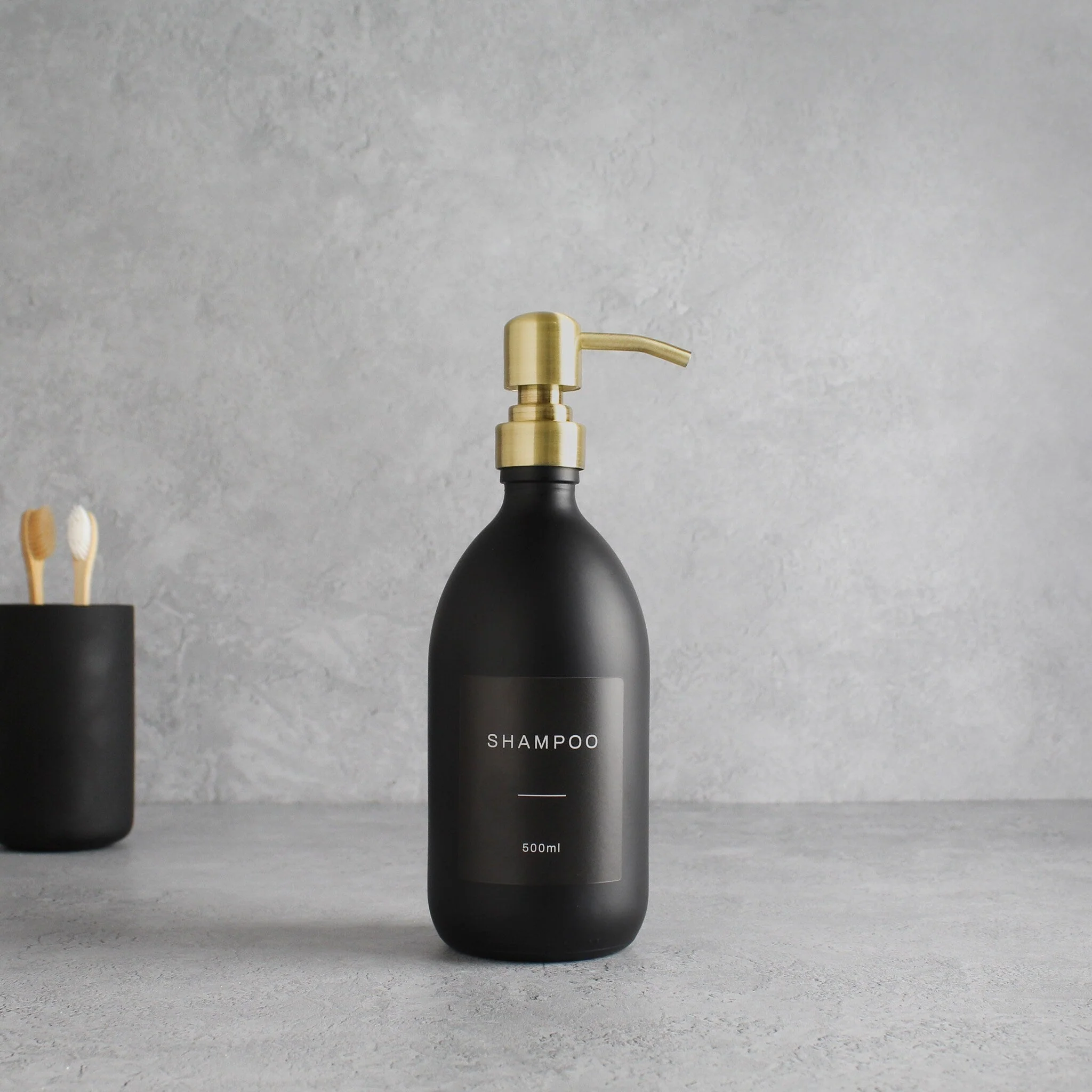 Labelled Matte Black Glass Dispenser Bottle With Gold Pump - Image 4