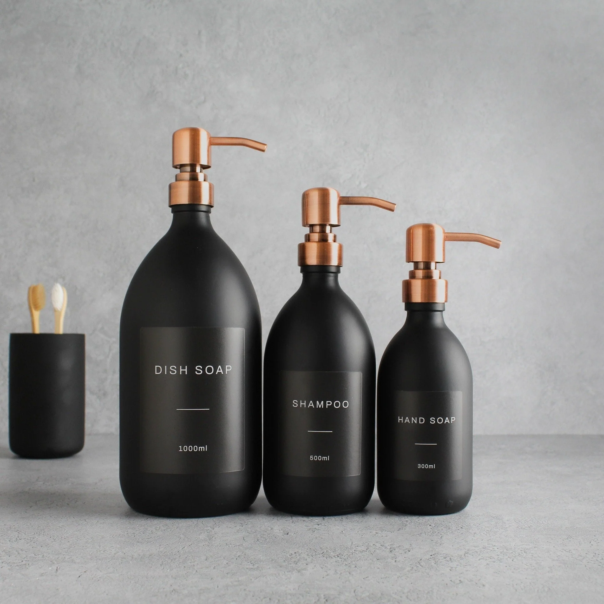 Labelled Matte Black Glass Dispenser Bottle With Rose Gold Pump - Image 2