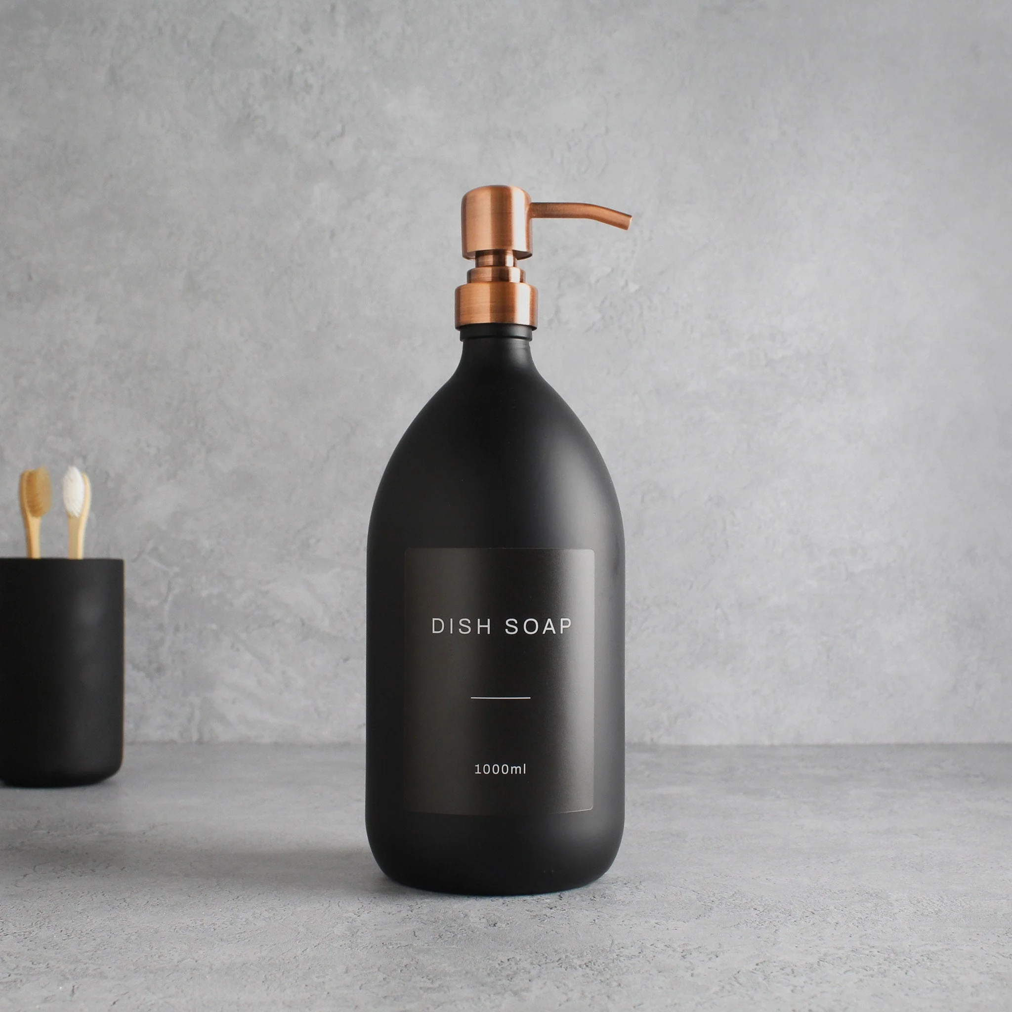 Labelled Matte Black Glass Dispenser Bottle With Rose Gold Pump - Image 3