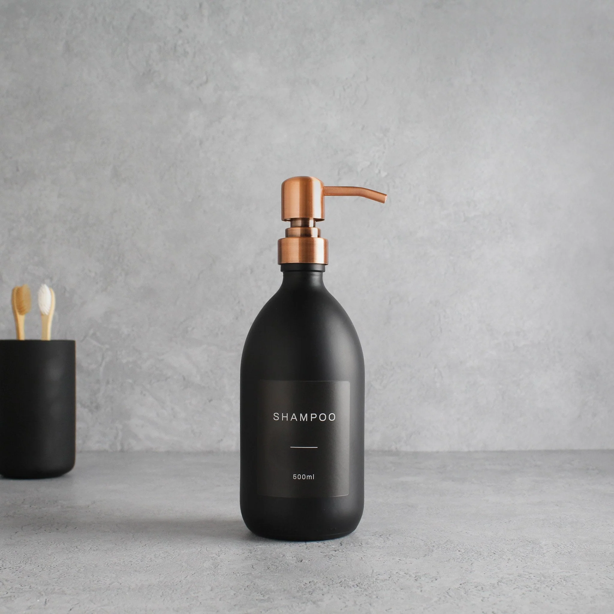 Labelled Matte Black Glass Dispenser Bottle With Rose Gold Pump - Image 4