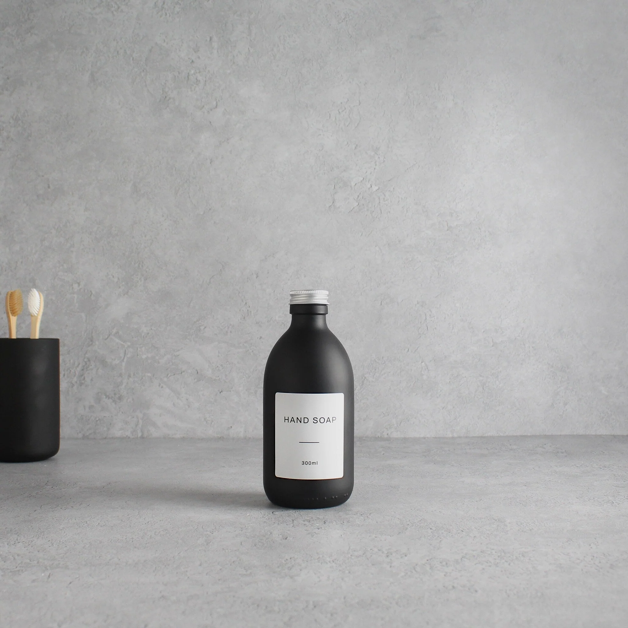 Labelled Matte Black Glass Bottle With Screw Cap - Image 5