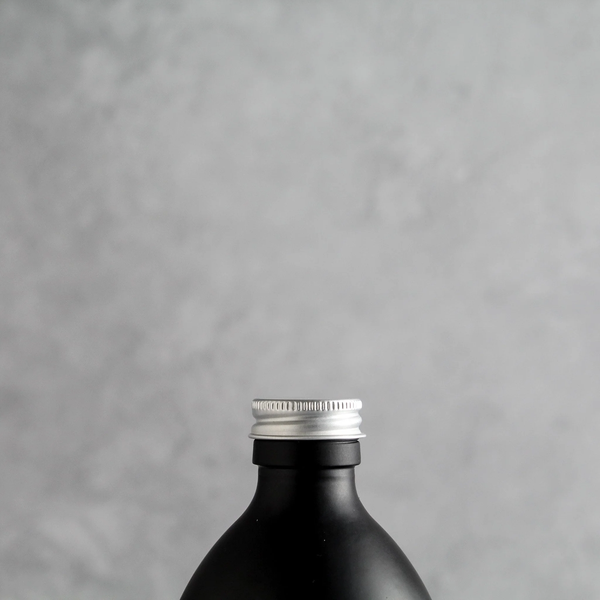 Labelled Matte Black Glass Bottle With Screw Cap - Image 6