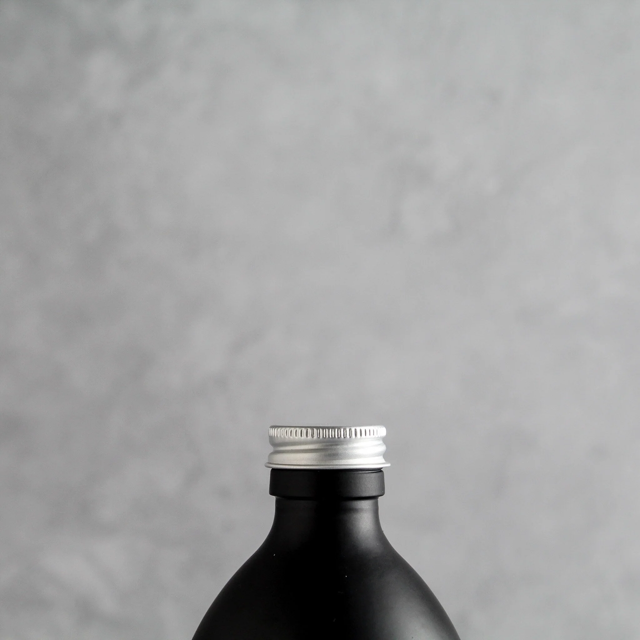 Labelled Matte Black Glass Bottle With Screw Cap - Image 6